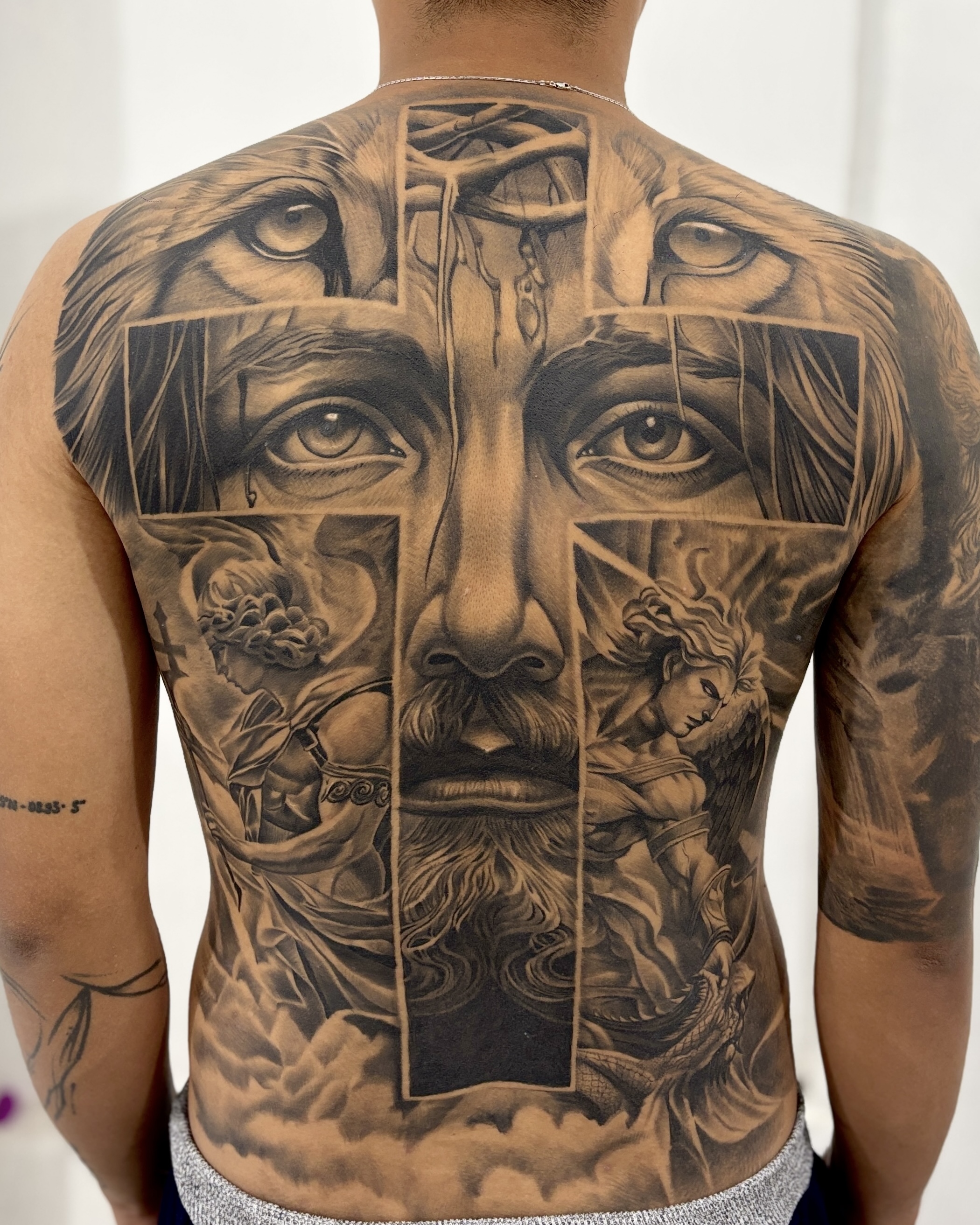 Fully healed black-and-grey realism back tattoo
